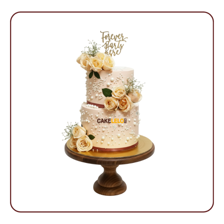 Timeless Union Cake – an elegant ivory tiered wedding cake with classic pearl and lace details, available in Kudasan.