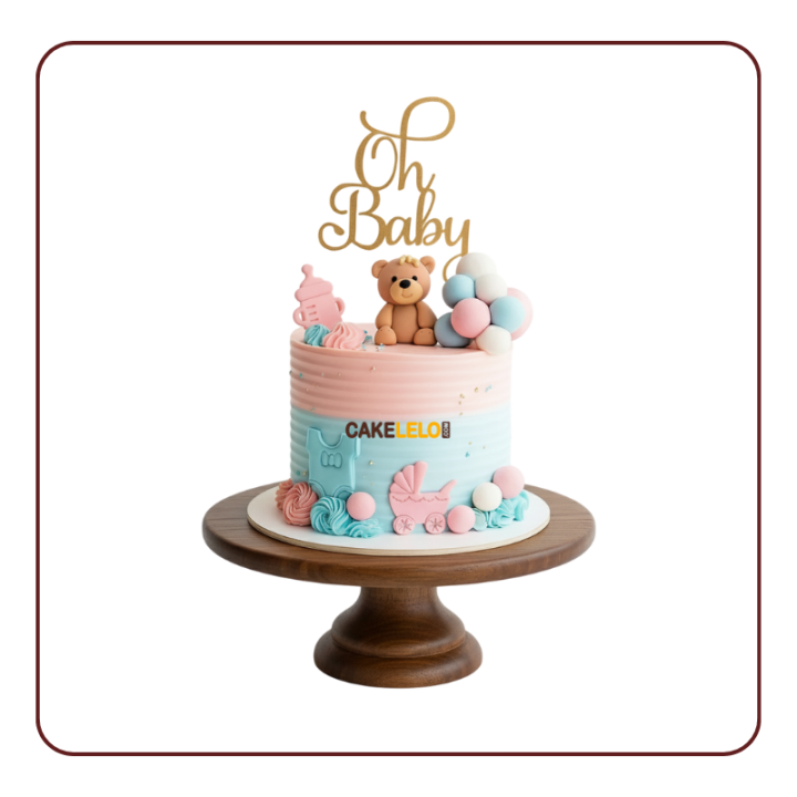 cake in pink and blue with fondant teddy bear, milk bottle, and Oh Baby acrylic topper - Best cake shop in Kudasan.