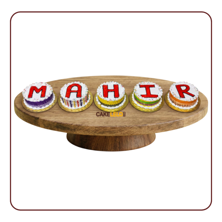 individual round cakes spelling "MAHIR" with colorful borders and red letter with different flavor of cakes.